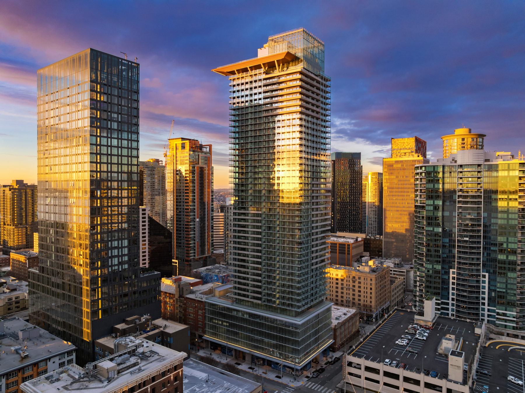 First Light tower glowing at dusk above the Seattle skyline
